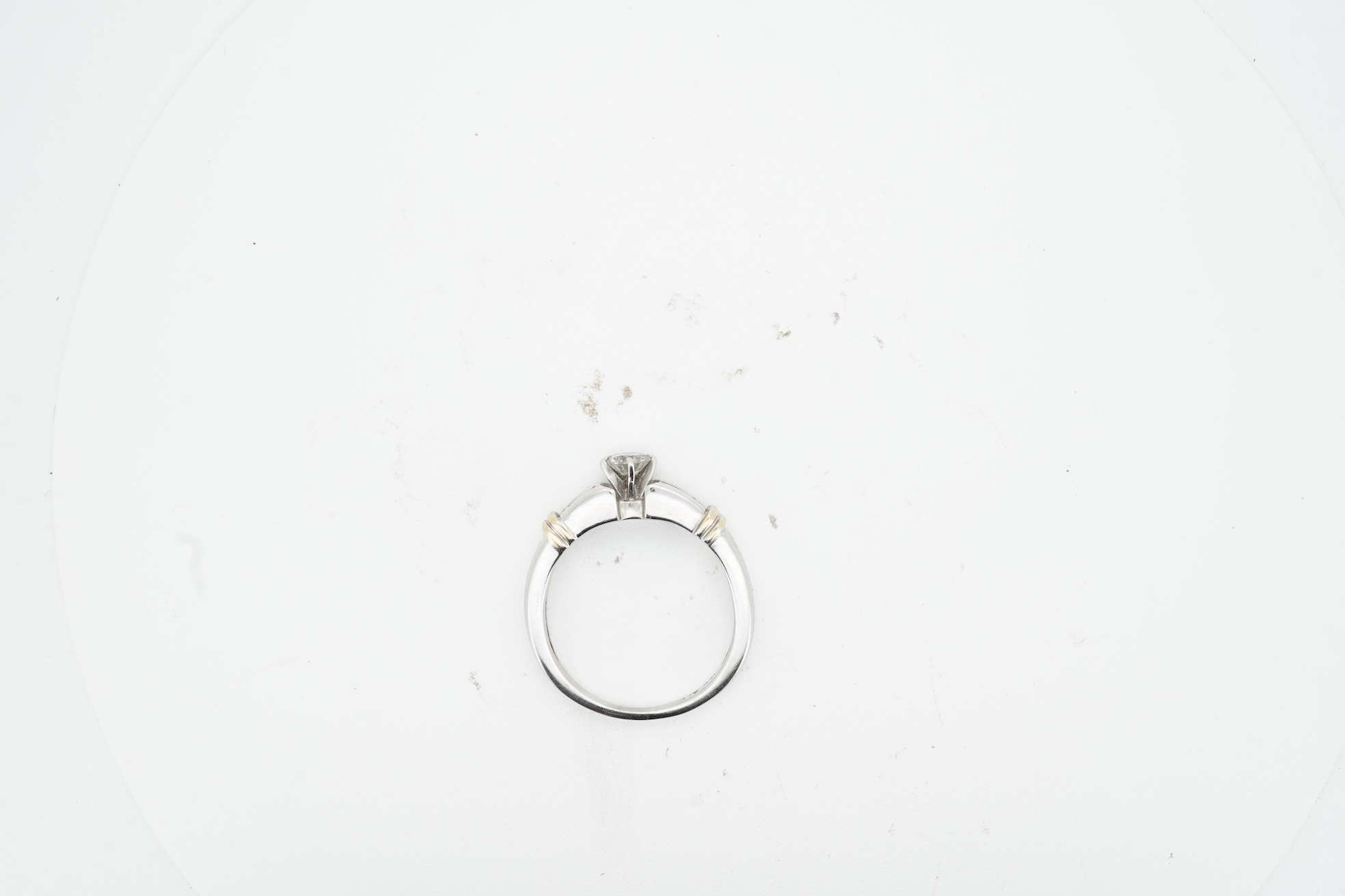 A diamond half-hoop ring, mid 19th century, pavé-set to the front with three rows of cushion-shaped diamonds totalling approximately 0.80 carats, to foliate carved shoulders, mounted in gold, size O, gross weight approxi